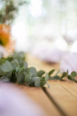 Bu büyüleyici görüntü, gerçek bir düğünün zarif dekorunu ve büyüleyici çiçek düzenlemelerini gözler önüne seriyor. Fotoğrafta zarif çiçekler, mumlar ve diğer dekoratif el ile süslenmiş büyüleyici bir düğün yerinde güzel dekore edilmiş bir masa yer alıyor.