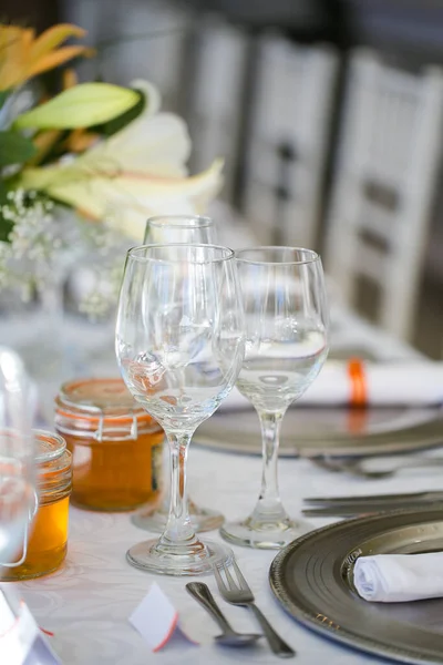 stock image This captivating image showcases the elegant decor and stunning floral arrangements of a real wedding. The photograph features a beautifully decorated table in a charming wedding venue, adorned with delicate flowers, candles, and other decorative ele