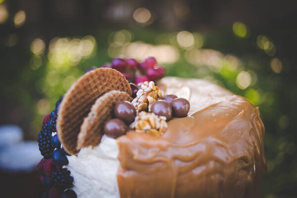 This image showcases a variety of stunning wedding cakes, ranging from tiered cakes to cup cakes. The photograph features an array of delicious cakes, each meticulously decorated with intricate details and delicate frosting. The cakes come in a varie