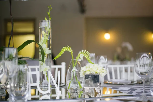 stock image This captivating image showcases the elegant decor and stunning floral arrangements of a real wedding. The photograph features a beautifully decorated table in a charming wedding venue, adorned with delicate flowers, candles, and other decorative ele