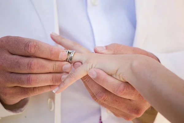 这张美丽的照片捕捉了一对夫妇在真正的婚礼上交换结婚戒指的亲密时刻 这张照片展示了这对新人的手的特写 展示了他们相互交织的手指和他们手指上的结婚戒指 — 图库照片