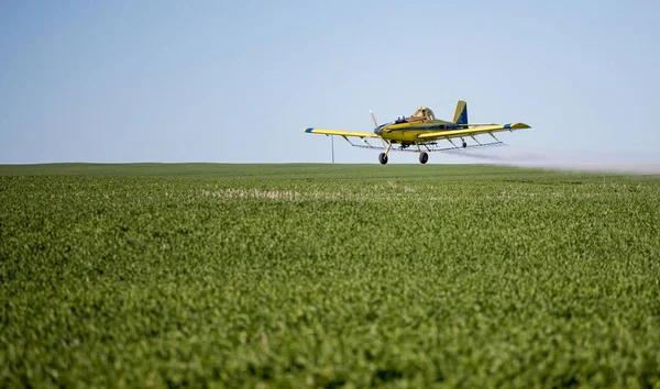 stock image Close up image of crop duster airplane spraying grain crops on a field on a farm