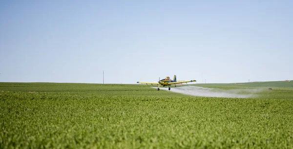 Stock image Close up image of crop duster airplane spraying grain crops on a field on a farm