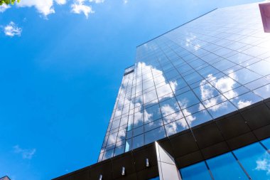 Timisoara, Timis Romanya, 24 Nisan 2023: Modern ofis binasının camlarına parlak bulutlar yansıdı