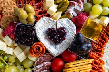 Charcuterie Board with fresh fruits, meats, and cheese clipart