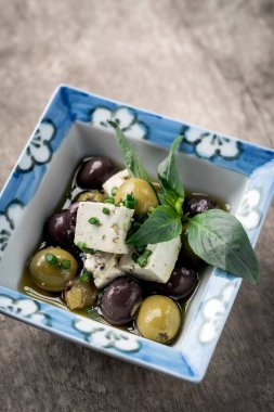 marinated spanish olives and feta cheese tapas in rustic barcelona restaurant