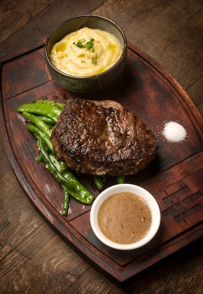 Rib Eye Beef Steak Butter Sauce Gravy Wood Background — Stok fotoğraf