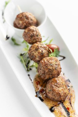 Beyaz arka planlı beyaz tabakta Tayland balıklı kek topları.