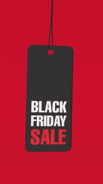 Sosyal medya için 4k Çözünürlük Dikey Videosu: Perakende ve Tanıtım Konsepti. Kara Cuma İndirimli Etiketi İpte Asılı ve Alfa Matte ile Kırmızı Arkaplanda İlerliyor