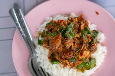 Tayland 'da pilavlı domuz eti. Kızarmış domuz eti ve fesleğenle birlikte. Tayland yemeği, baharatlı yemek..