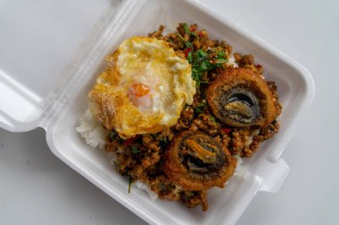 Stir Fried Basil with Spicy Century Egg Served with steamed rice and chili fish sauce, Thai food.