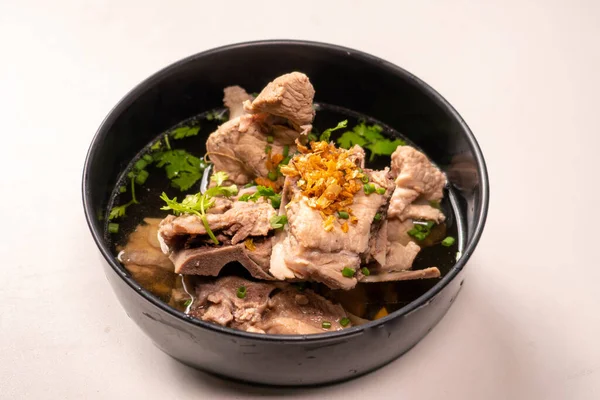 stock image Hot clear soup of fresh pork rib seasoning with soy sauce and pepper. Famous traditional freshness soup in Asia restaurant. Soft and selective focus concept.