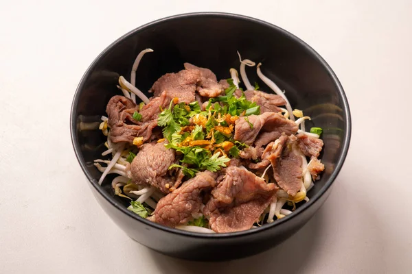 stock image Instant - Boiled Beef dip with hot in white dish and sour sauce in Thai food style on top view, scald thin slices of beef in boiling water; instant-boil in Thai food style