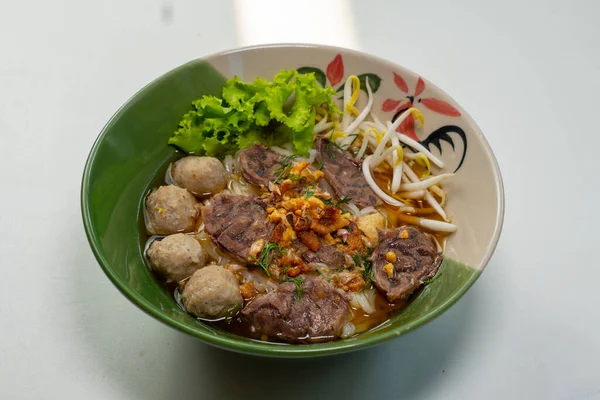 Stock image asian noodle soup with beef meatball with fresh vegetable on wood table vintage style, street food, hot and spicy noodle soup