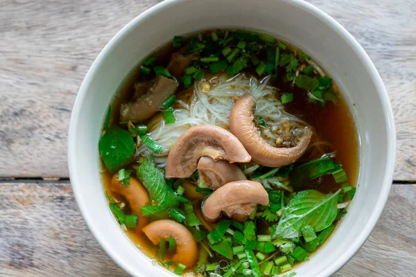 stock image Rice Noodles Beef Soup with Beef Intestine Braised ontop Garlic and Stink Weed decorate Spring onions and Basil Thai herbs. Thai Boat Noodles Style topview