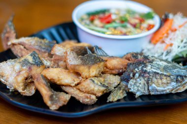 Pla Kapong Tod Nam Pla - Balık soslu kızarmış deniz pirinci, baharatlı mango salatası ve deniz ürünleri sosuyla servis