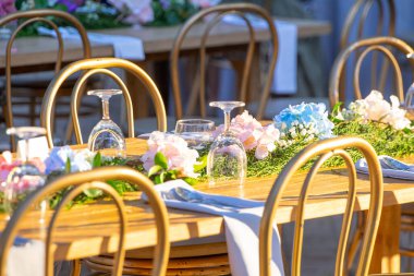 Beautiful flowers decorated on the table.Tables set for an event party or wedding reception. luxury elegant table setting dinner in a restaurant