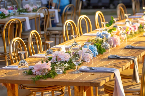 Beautiful flowers decorated on the table.Tables set for an event party or wedding reception. luxury elegant table setting dinner in a restaurant