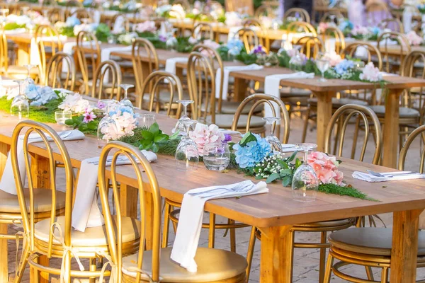 Beautiful flowers decorated on the table.Tables set for an event party or wedding reception. luxury elegant table setting dinner in a restaurant