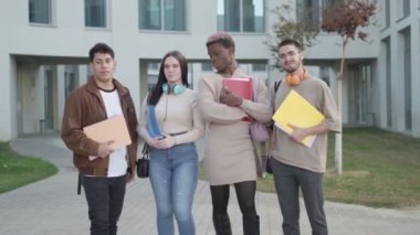 Multi-ethnic group of university students posing standing on the university campus