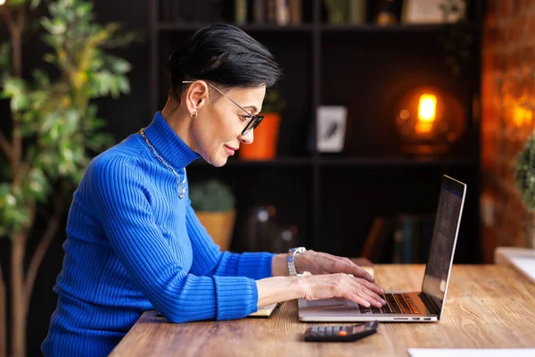 Side View Middle Aged Female Manager Blue Turtleneck Glasses Typing — Stock Photo, Image