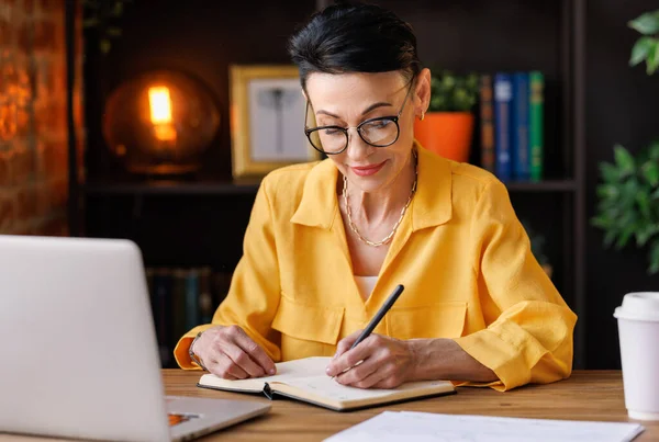 Focused Middle Aged Female Entrepreneur Working Laptop Take Notes While — Stock Photo, Image