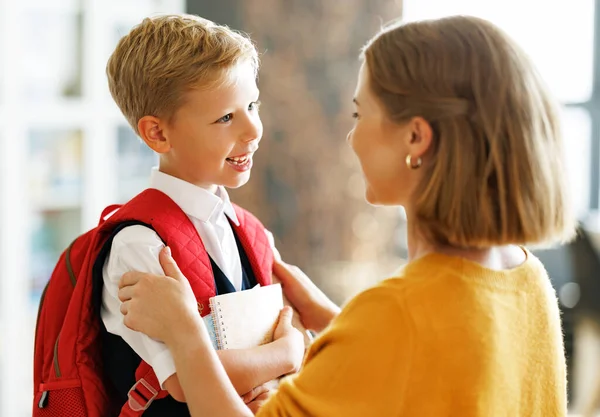 First Day School Mother Adjusts Briefcase Her Happy Son Preparing — Stock Photo, Image