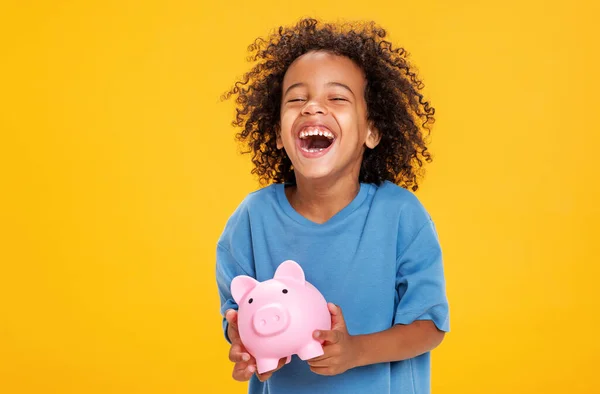 Positive African American Boy Casual Outfit Laughing Saving Money Piggy Royalty Free Stock Images