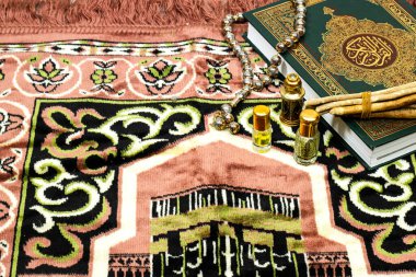 Kuran 'ın anlamı Arapça olan kutsal Kur' an ve namaz örtüsü, tespih ve parfüm.