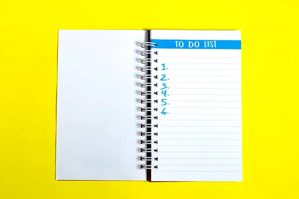 To do list of things or tasks to complete for life habit, business project plan concept, notepad with headline To do list and list of numbers  on yellow background