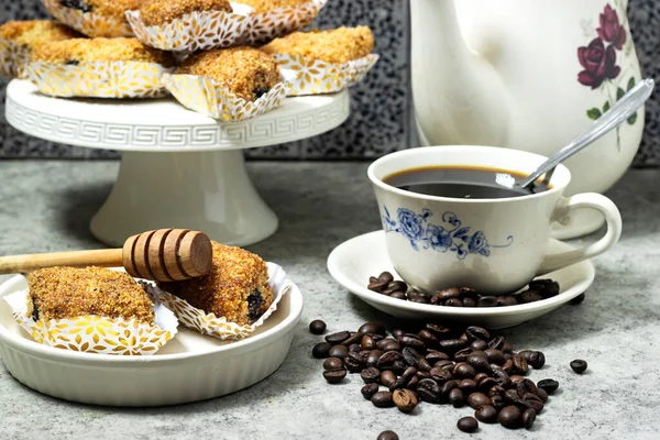 Fried Makrout or makroud - Algerian semolina, dates and honey sweets, traditional North Africa sweet food for islam with cup of coffee and roasted grain