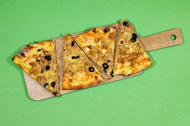 slice tuna pizza with cheese and tomato on wooden cutting board isolated