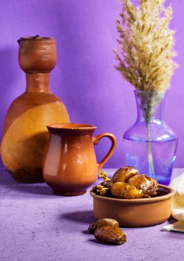 dates fruits with clay bottle and jar and reeds vase 