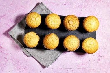 Vanilla Caramel Nuts Muffins In Paper Cups On black plate 