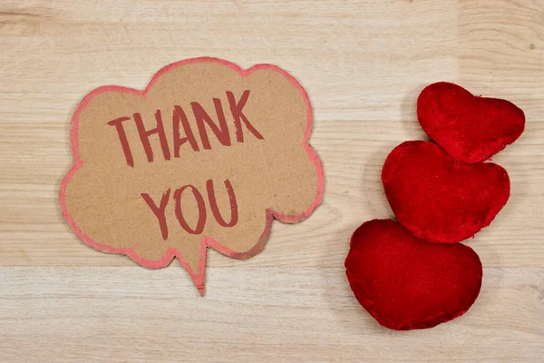 thank you concept on chat bubble with heart on wood table