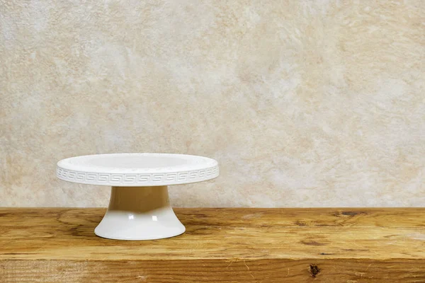 Stock image empty white cake stand on wooden table