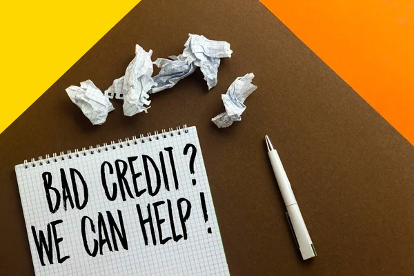 bad credit ? we can help ! concept  on notebook with crashed papers