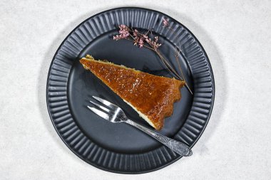 Ev yapımı tatlı romlu baba kayısı reçeli ve jigolo çiçeğiyle süslenmiş.