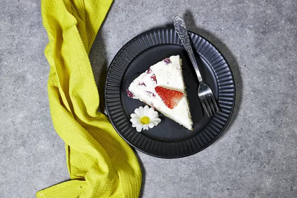 strawberry cake or Fraisier in french language in black plate  on grunge gray background