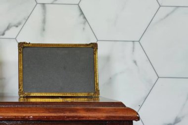 boş resim çerçevesi maketi ve altın kamış vazosu ahşap masa üzerinde altıgen mermer duvar, sonbahar sonbahar sonbahar konsepti