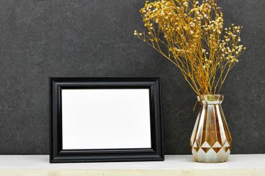 boş resim çerçevesi maketi ve çingene vazosu grunge duvarının yanındaki ahşap masa, sonbahar sonbahar sonbahar konsepti