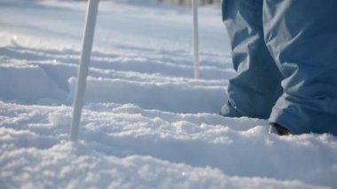 Kayak yapan bir çocuk. Yaratıcı. Beyaz karda duran ve büyük sopaları tutan bir çocuk. Yüksek kalite 4k görüntü