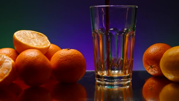 보라색 배경에 유리에 주스를 건강한 식단과 비타민 카운터에 오렌지의 — 비디오