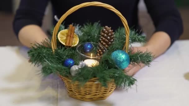 松の木の枝とおもちゃのボールが付いている小さなバスケットの近く アート クリスマスの装飾 冬休みのコンセプト — ストック動画