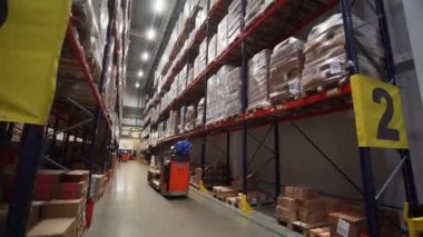 Estonya-Tallinn, 21.04.2023: Aksiyon. Özel raflara yerleştirilmiş büyük paketlerin olduğu geniş bir odada çalışmak. Sadece başyazı için kullan. Yüksek kalite 4k görüntü