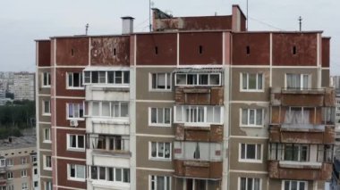 Şehrin uyku alanındaki tipik bir çok katlı bina manzarası. Stok görüntüleri. Pencereleri ve balkonları olan eski apartman dairesi.