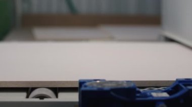 Taşıyıcı ve tahta tahtaları olan endüstriyel bir makine. Yaratıcı. Endüstriyel modern makinede beyaz tahta hareket eder. Fabrikadaki tahtaları işlemek için taşıyıcı.. 