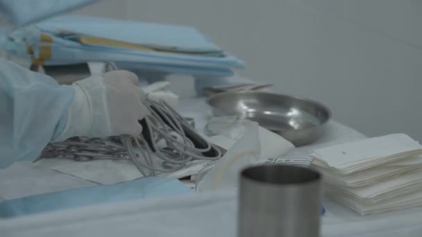 手術の準備のためにテーブルの上に医療用具のテーブルが置かれています ストック映像 テーブルの上に楽器を置く看護師 — ストック動画