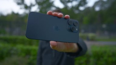 İngiltere, Londra - 15 Eylül 2023: Adam yeni iPhone 'da fotoğraf çekiyor. Başla. Yeni iPhone 15 'te elma logosu. Yeni iPhone 15 profosyonel çekimleri. 