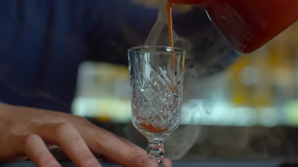 酒吧柜台旁的酒保关门 把酒倒进老式玻璃杯里 用蒸汽浇红色热酒精药水 — 图库视频影像